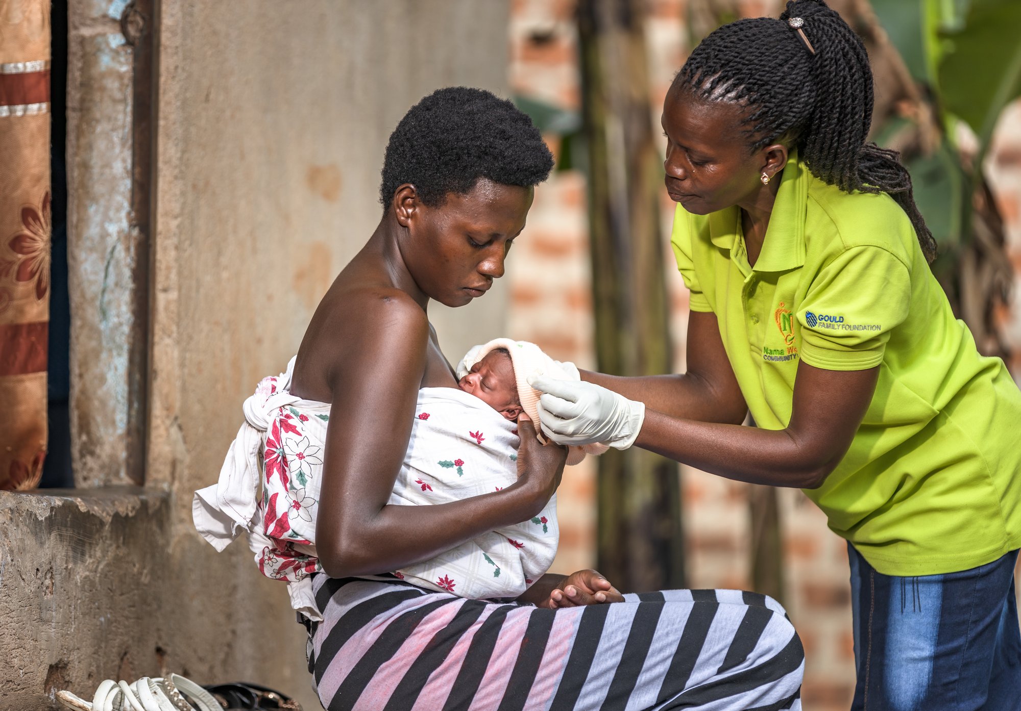 A Frontline Worker guides a mother on KMC positioning as part of a Connect KMC visit A Frontline Worker guides a mother on KMC positioning as part of a Connect KMC visit
